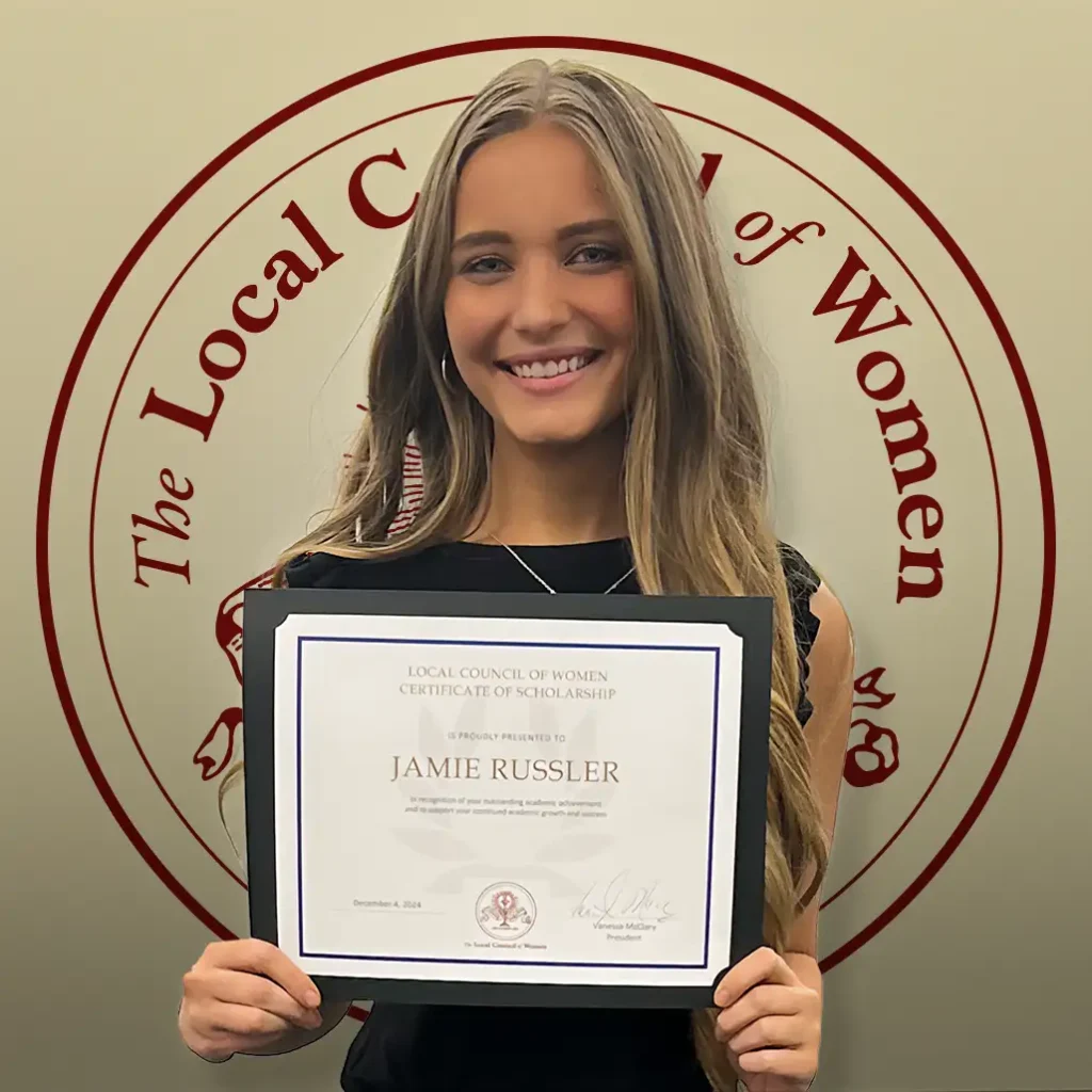 Jamie Russler holding her $1,000 scholarship certificate at the 2024 LCW Annual Meeting.