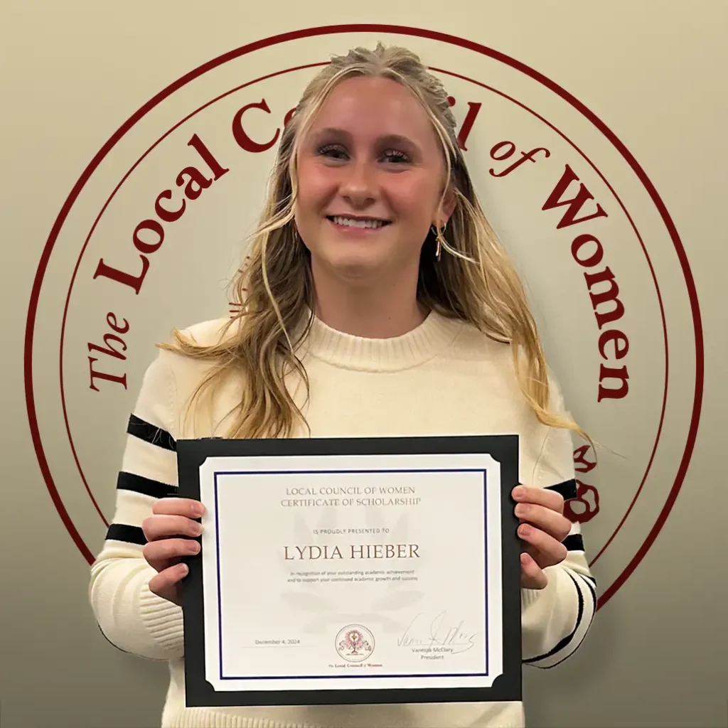 Lydia Hieber holding her $1,000 scholarship certificate at the 2024 LCW Annual Meeting.