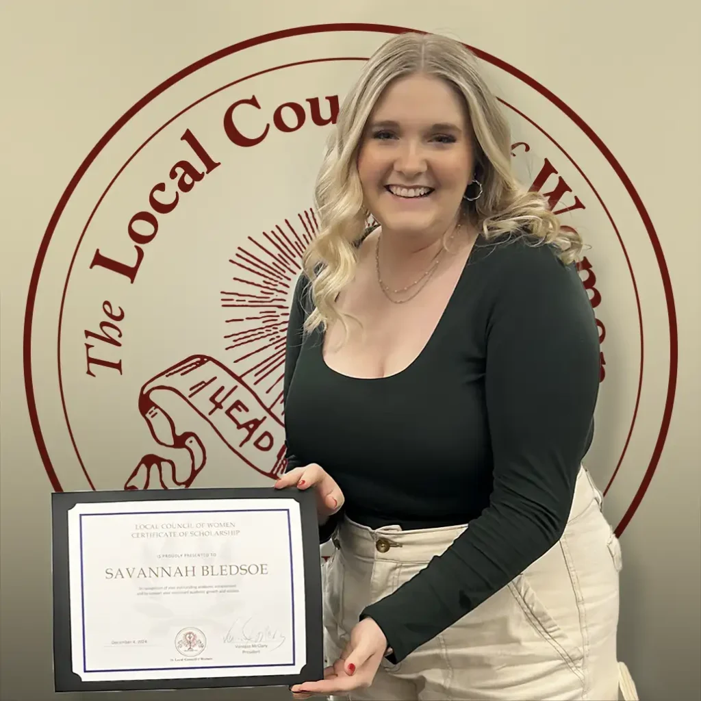 Savannah Bledsoe holding her $1,000 scholarship certificate at the 2024 LCW Annual Meeting.